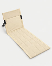 Alphes Shoreline folding beach chair in beige, laid out flat with its padded backrest propped up